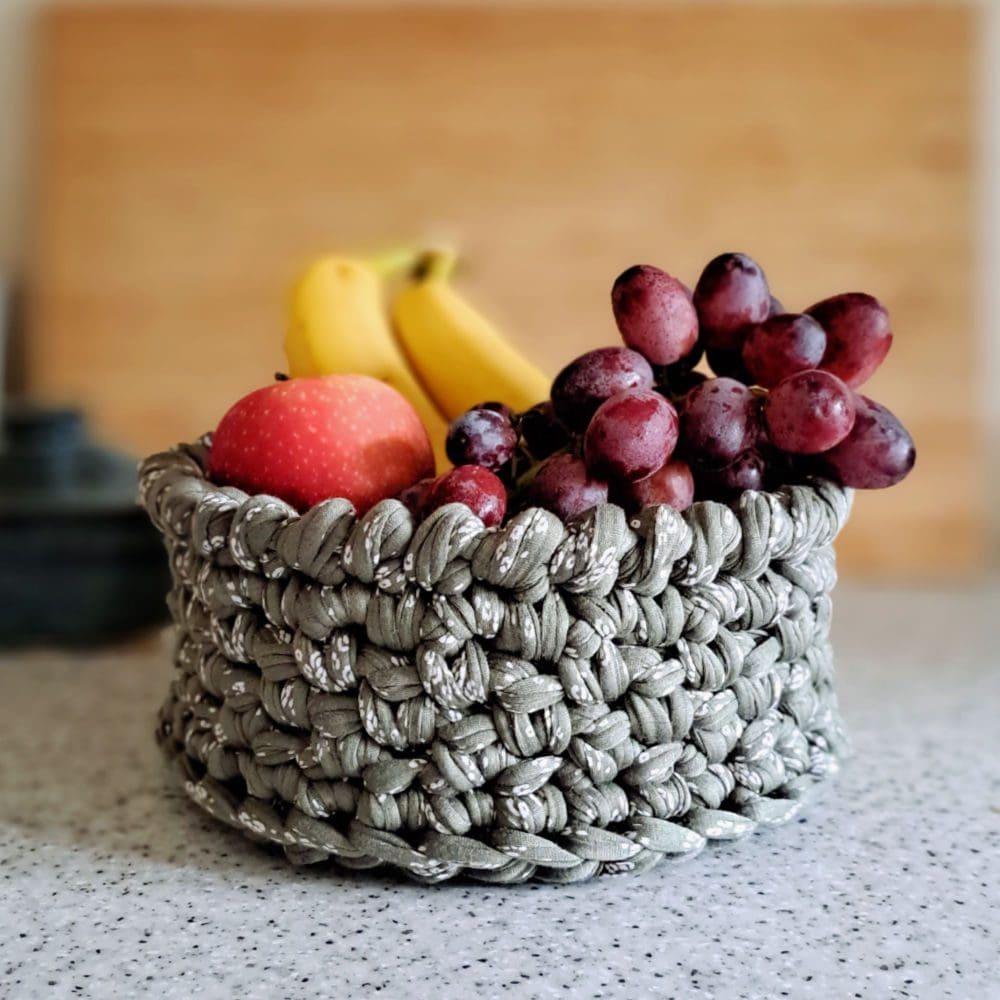A green floral crochet storage basket