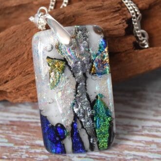 Handmade Glass Jewellery. A dichroic pendant hung with a pinch bail on a silver plated chain.