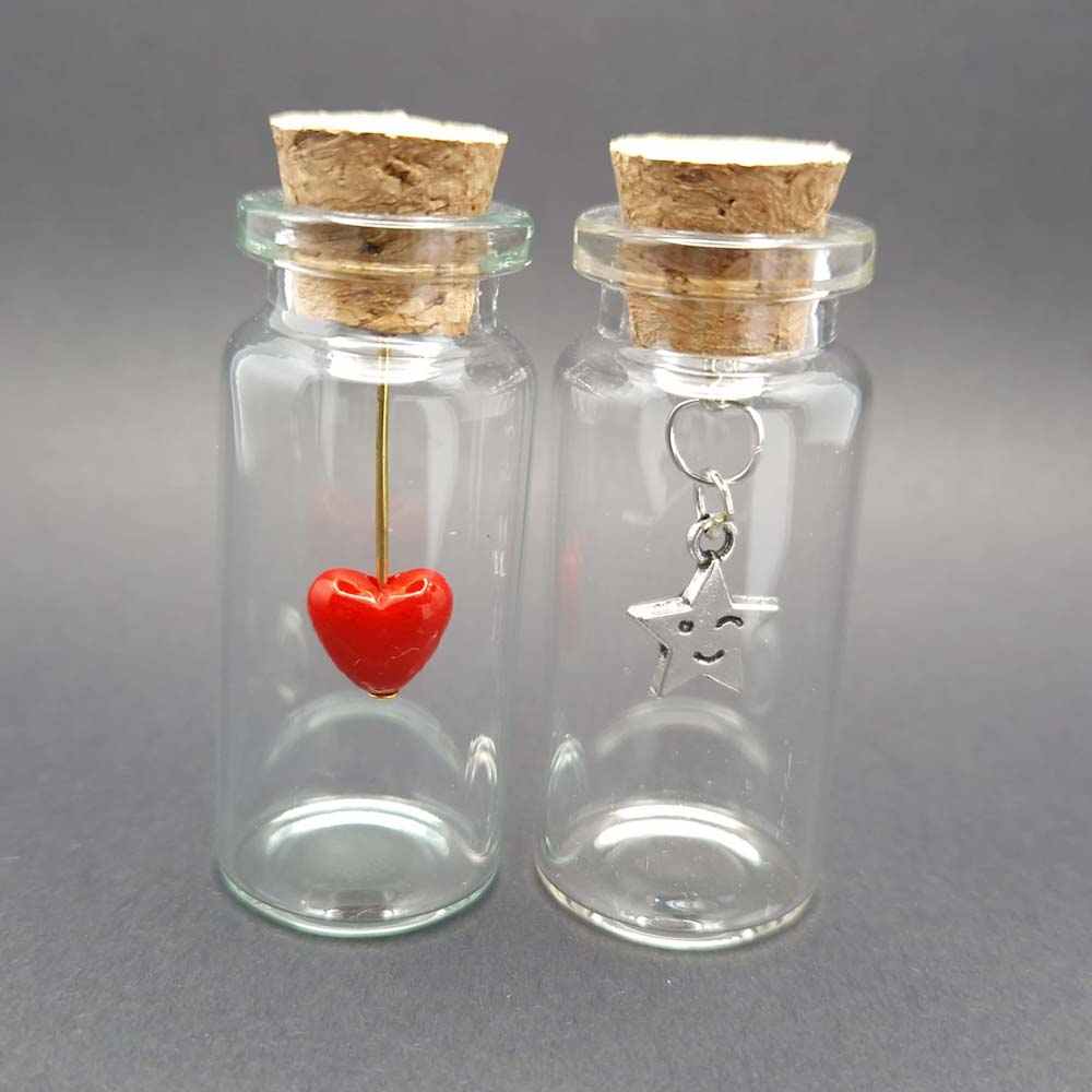 miniature glass bottles with a heart and smiling star charms