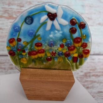 Handmade Glass Globe shape with white and red flowers. A meadow scene
