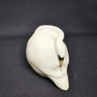 Ceramic mute swan, with neck curled into wings as though sleeping