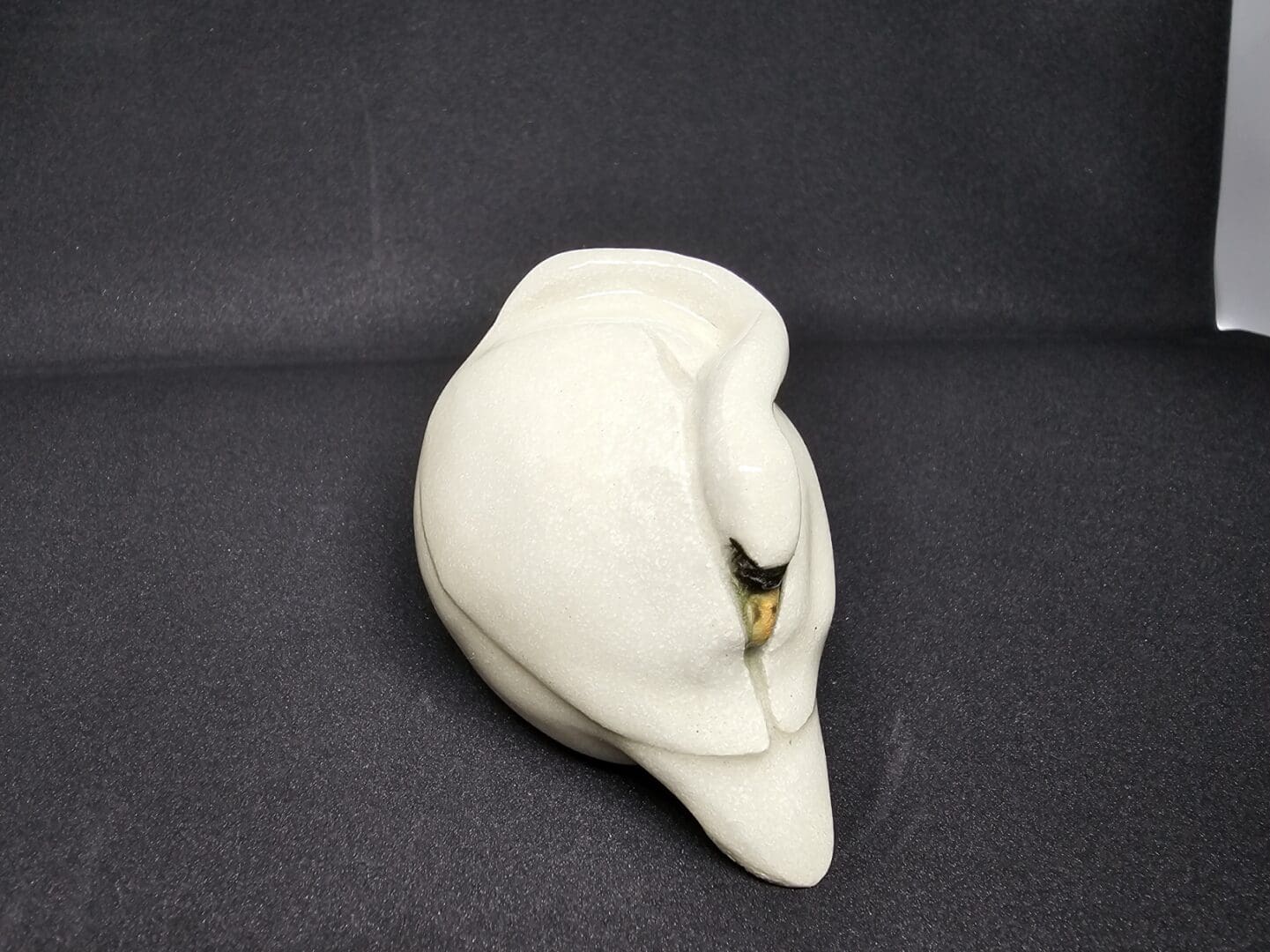 Ceramic mute swan, with neck curled into wings as though sleeping