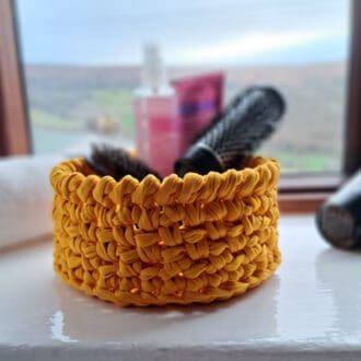 Yellow bathroom storage crochet basket