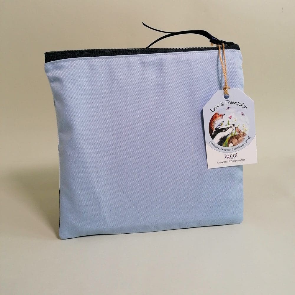Pale blue cotton back view of the Beagle toiletries bag with a chunky zipper fastening and satin ribbon zipper pull.