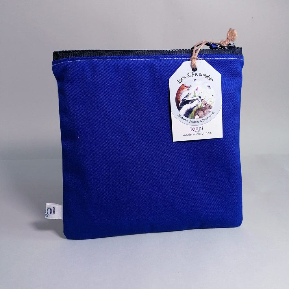 Bright blue cotton back view of the Bee toiletries bag with a chunky zipper fastening.