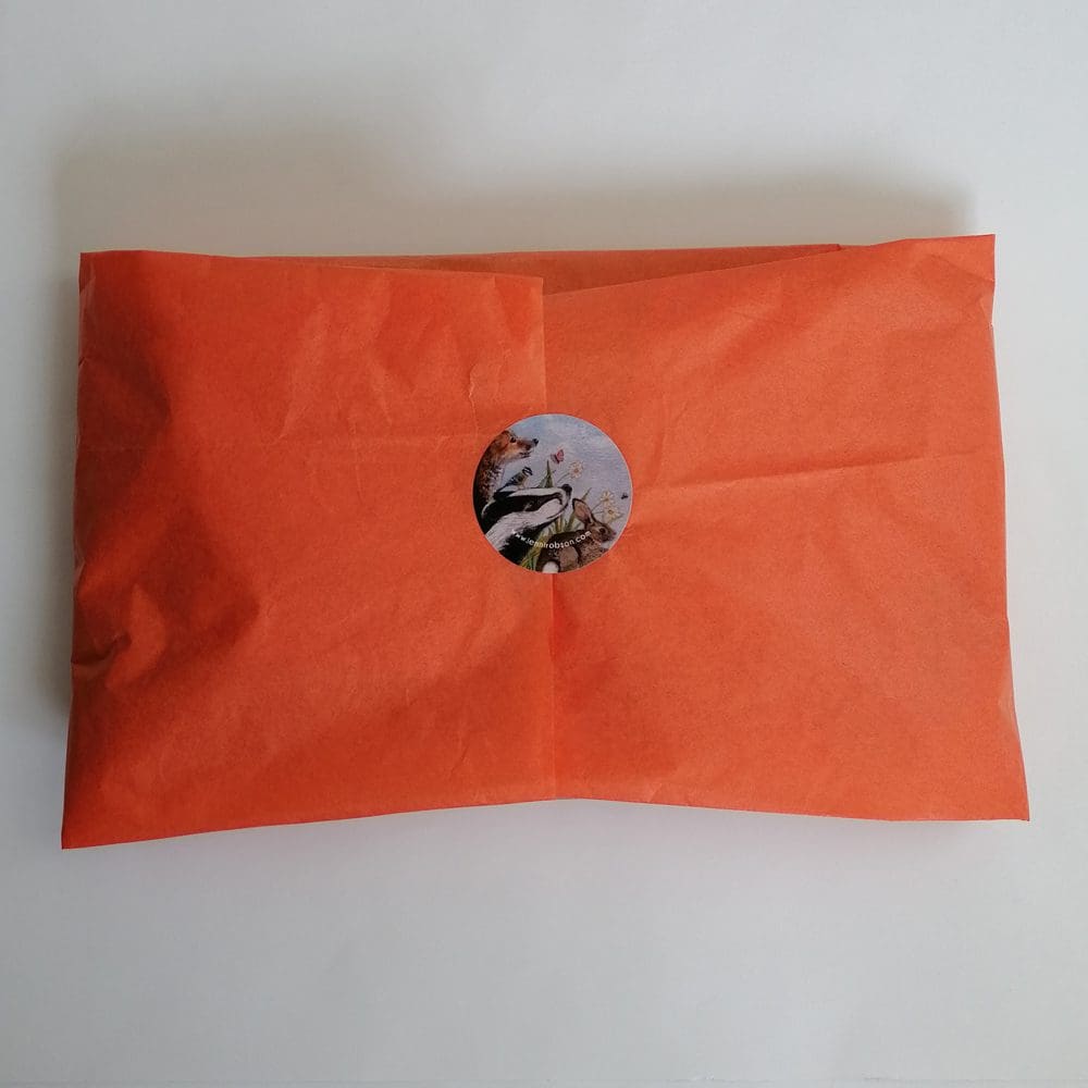 Coloured tissue paper packaging sealed with a character sticker