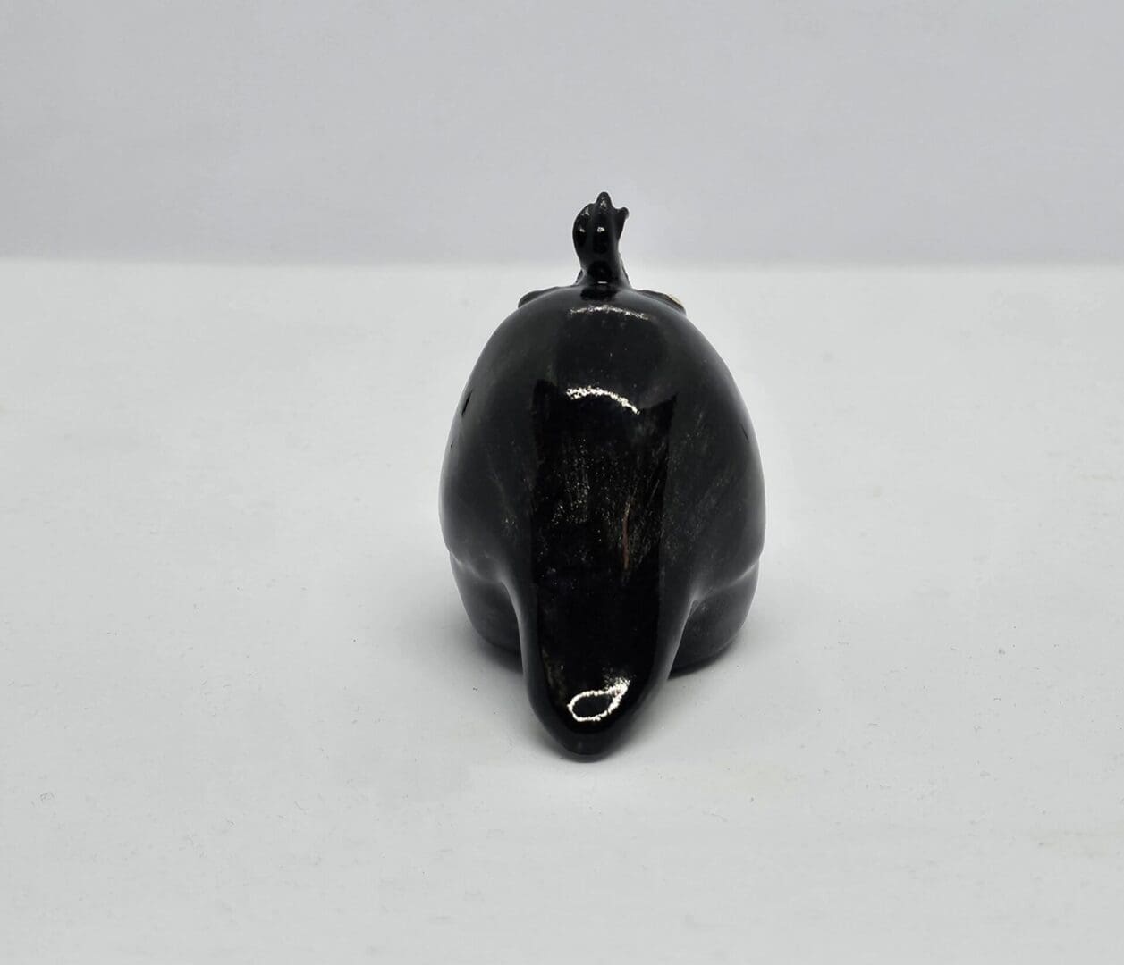 Back view of ceramic auklet, on a white background