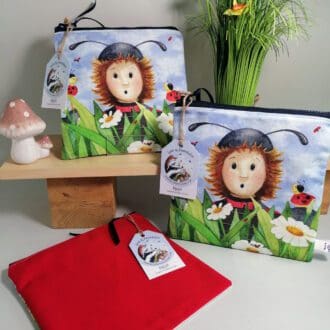 Cotton toiletries bag featuring a character in a ladybug costume amongst the daisies. Bright red cotton back with a water resistant lining and internal pocket. Sealed by a chunky zipper. Great as a pencil case or overnight washbag