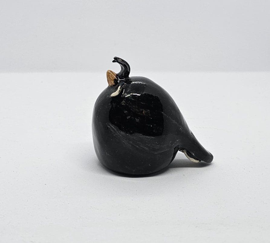 Side view of ceramic auklet on white background