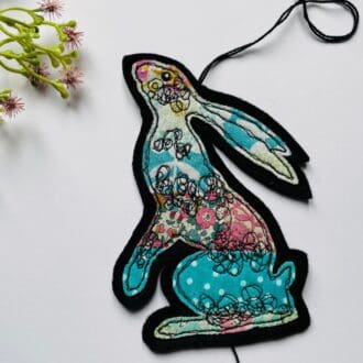 Blue and pink moon gazing hare hanging decoration with patchwork free motion detail and spotty hanging heart, stocking filler gift