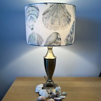 Handmade seashells drum lampshade in turquoise, blue and white cotton fabric.
