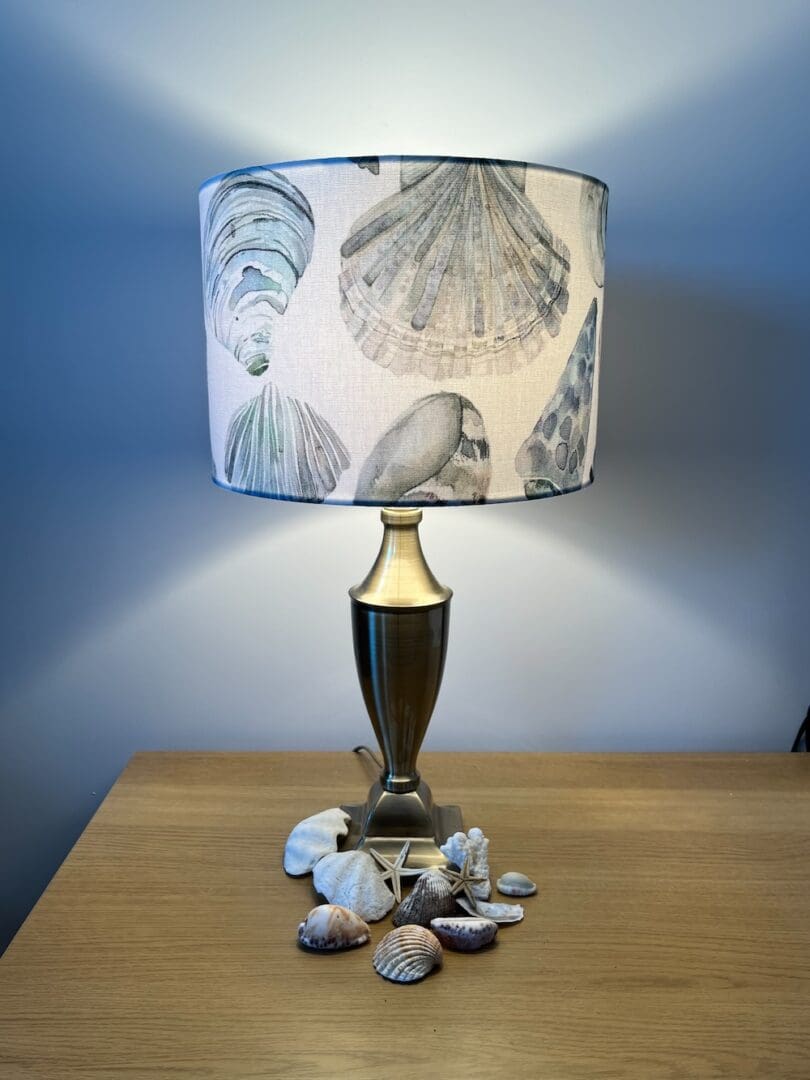 Handmade seashells drum lampshade in turquoise, blue and white cotton fabric.