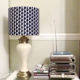 Handmade drum lampshade in navy featuring a crescent moon motif.