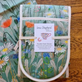 Wildflower oven gloves with towelling reverse, printed with illustrations of poppies, daisies and a friendly bee.