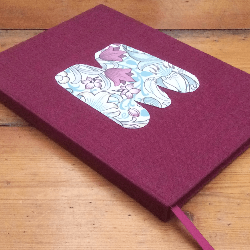 M Monogrammed Notebook covered in fabric with plain paper