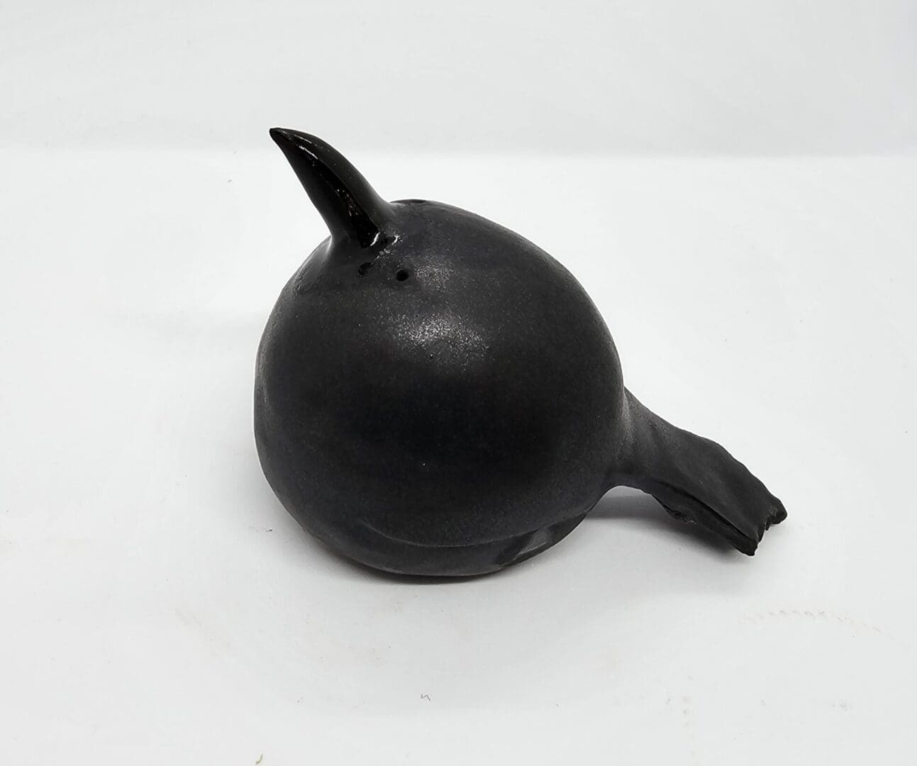 Ceramic crow facing to the left