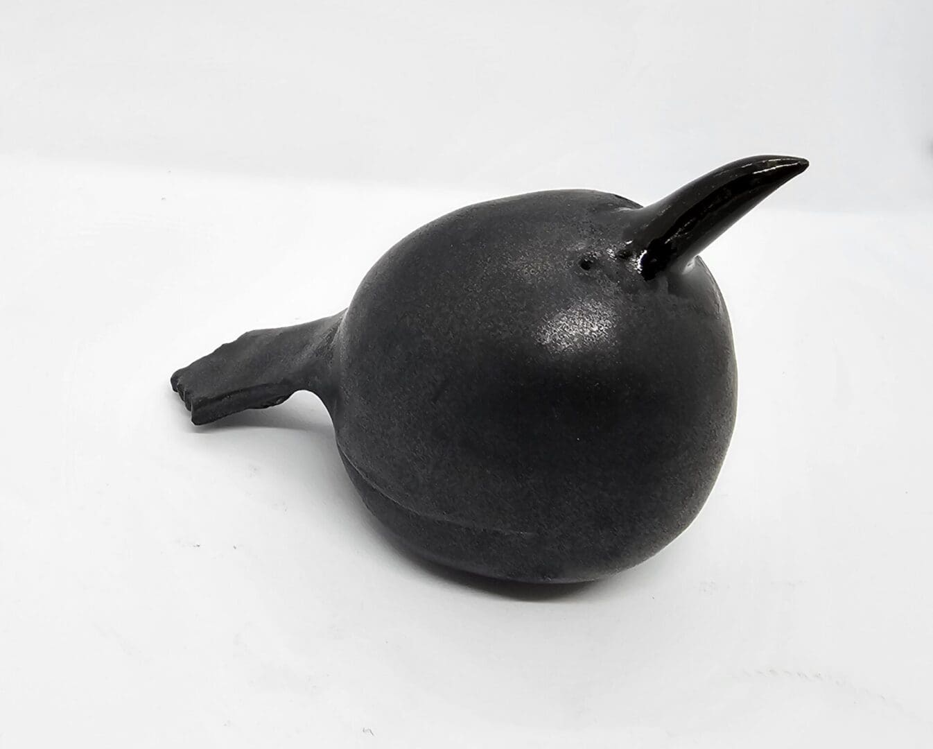 Ceramic crow facing to the right