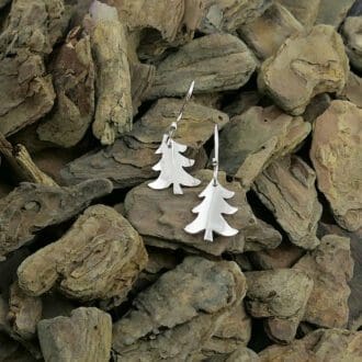 recycled-sterling-silver-christmas-tree-eard-drops-on-a-wood-chip-background