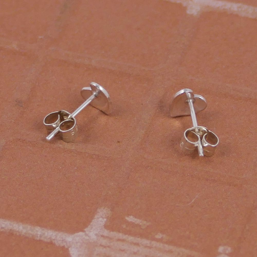 small-heart-ear-studs-seen-form-the-back-on-a-tile-background