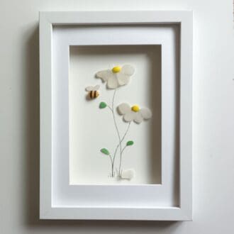 framed picture of two sea glass daisies