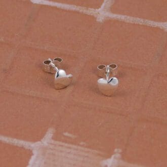 small-heart-ear-studs-on-a-tile-background