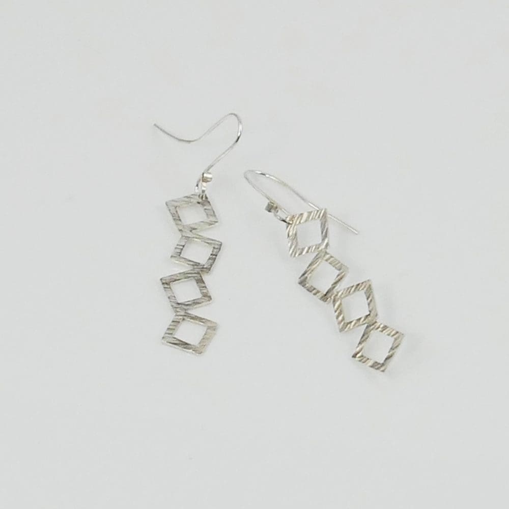 tumbling-squares-drop-earrings-on-a-white-background