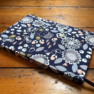 A5 handmade notebook with lined paper covered in abstract floral fabric