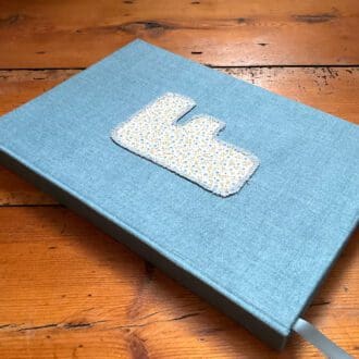 IA5 fabric covered notebook personalised with an F initial on the front