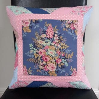 Quilted cushion with flower bouquet design in pink and blue