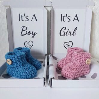 pregnancy Gender Reveal Announcement Idea, a pair of newborn handmade crochet baby booties in a box saying its a boy or its a girl, personalised text can also be chosen