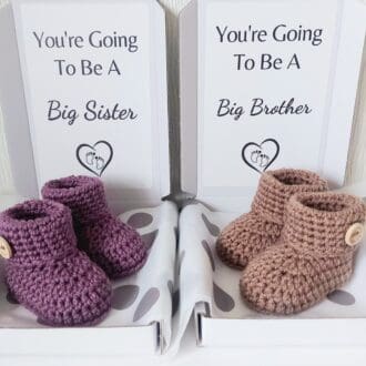 Pregnancy reveal to your children. You're going to be a big brother or big sister reveal announcement. A pair of hand crochet newborn booties presented in a letter box size box. text can also be personalised