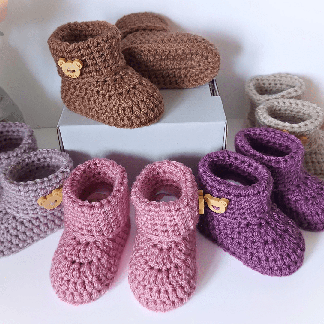 teddy bear button finished handmade crochet baby booties with a folded cuff. There are various colours to choose from and they are in sizes newborn, 0-3 and 3-6 months