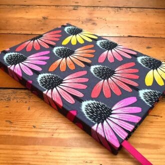 A5 handmade notebook filled with lined paper covered in Echinacea patterned fabric