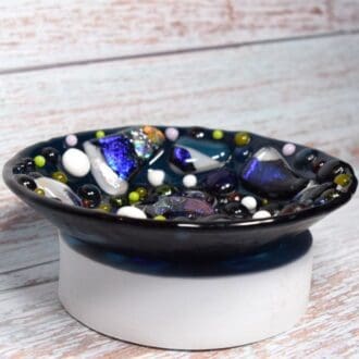 unusual handmade blue glass bowl with multicoloured dichroic pieces