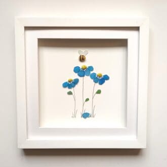 framed picture of forget me nots and a bee made from Cornish sea glass