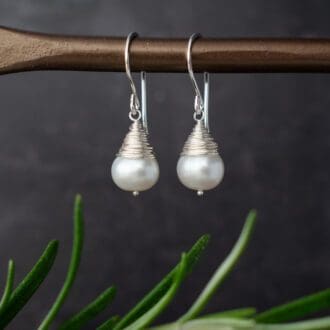 pearl earrings featuring pearls wrapped with wire to form a teardrop shape.