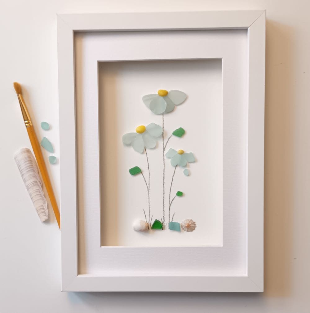 framed picture of three pale blue sea glass flowers