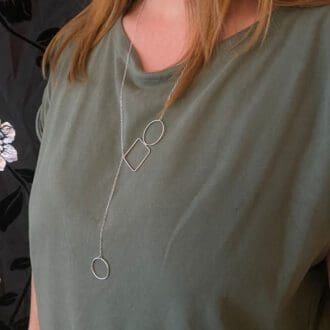 recycled sterling silver circle and square lariat style necklace being worn
