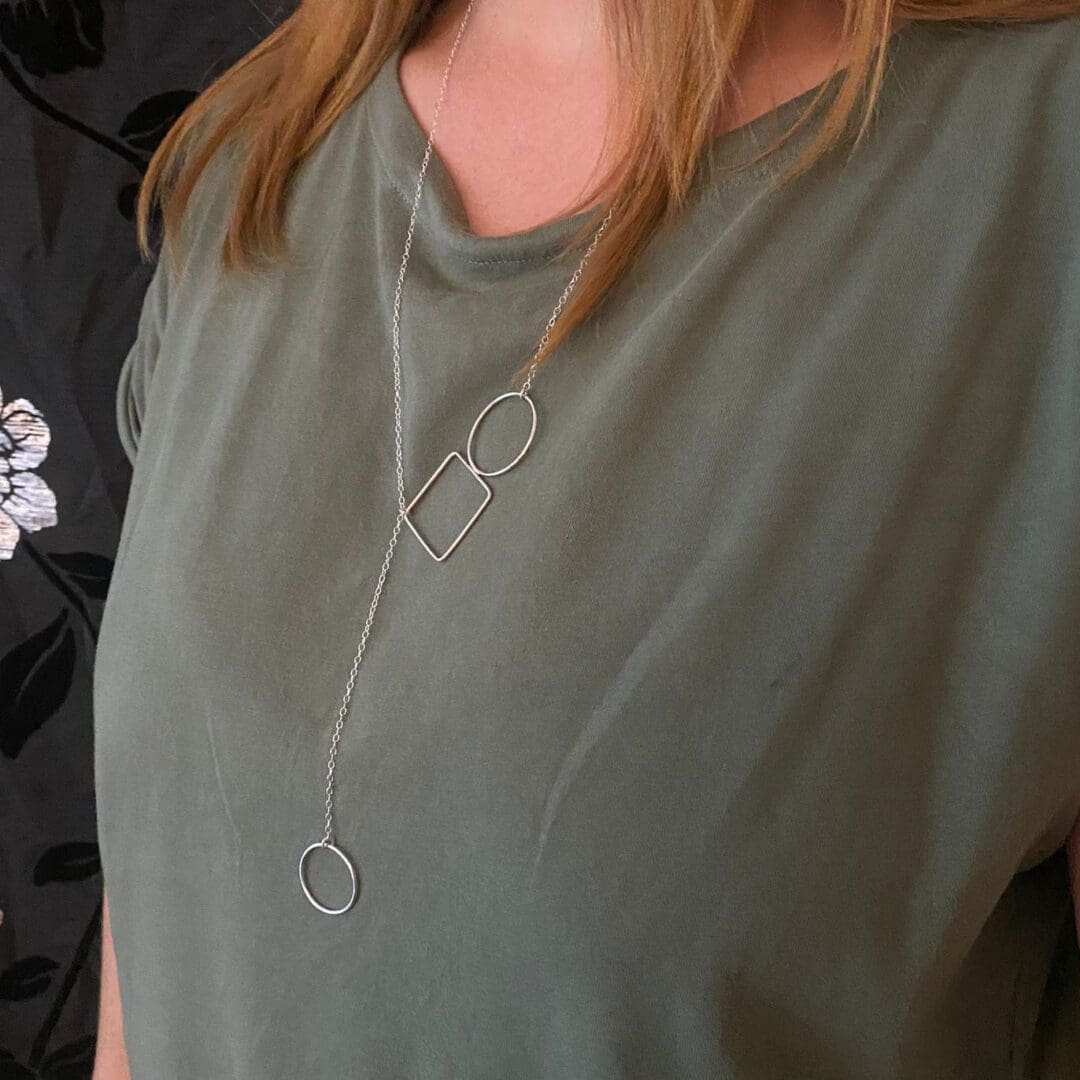 recycled sterling silver circle and square lariat style necklace being worn