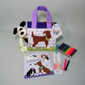 Gorgeous pale and dark purple cotton bookbag with water resistant lining featuring a smart brown dog in his best green bandana illustration. The bag contains a stapled blank 20 page sketchbook featuring a selection of dogs and furry friends, 14 mini colouring pencils with a laminated bookmark printed with a mouse theme. Ideal for kids who love to draw.
