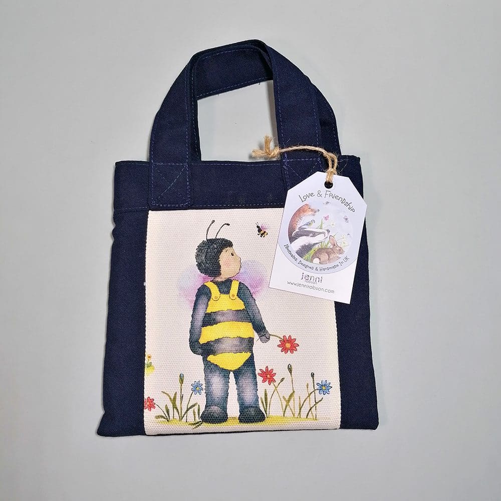 Little navy blue cotton handbag water resistant lining featuring Gabriel and Buzby bee illustration. The bag contains a coil bound sketchbook featuring pirates in a bathtub, a pencil with an eraser character topper and a laminated bookmark printed with Gabriel and bee friend. Ideal for kids who love to draw.