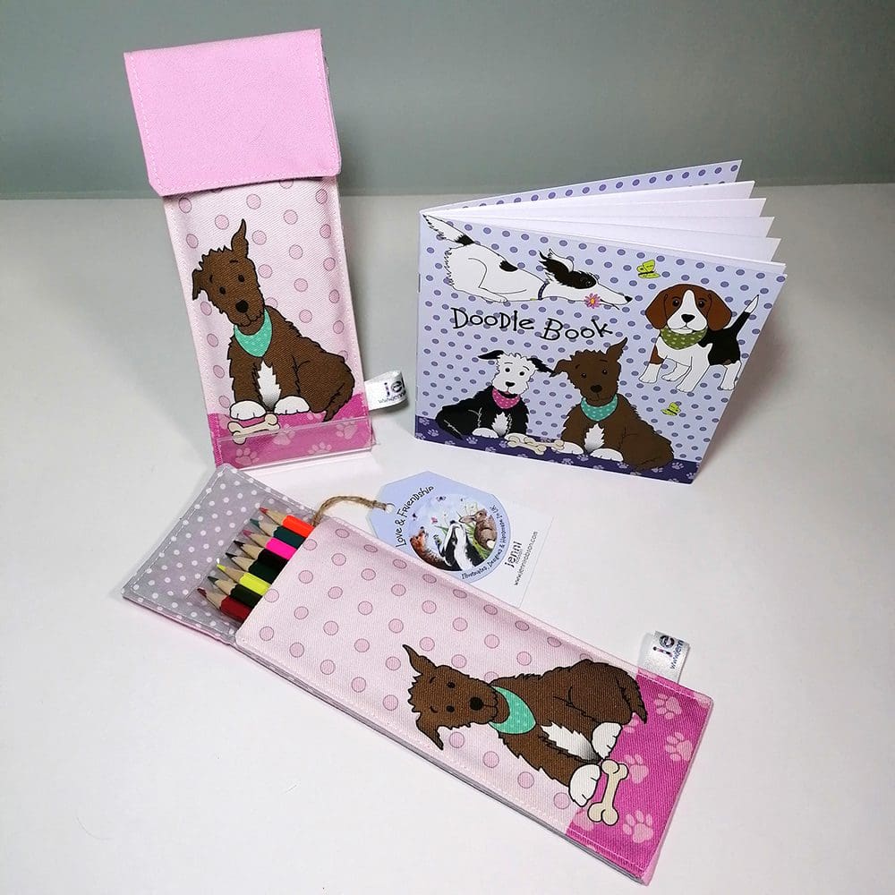 Brown dog in a turquoise bandana Doodle Kit, stationery set. Comprising of a lined handmade cotton pink pouch, 8 colouring pencils and a 20 page sketchbook.
