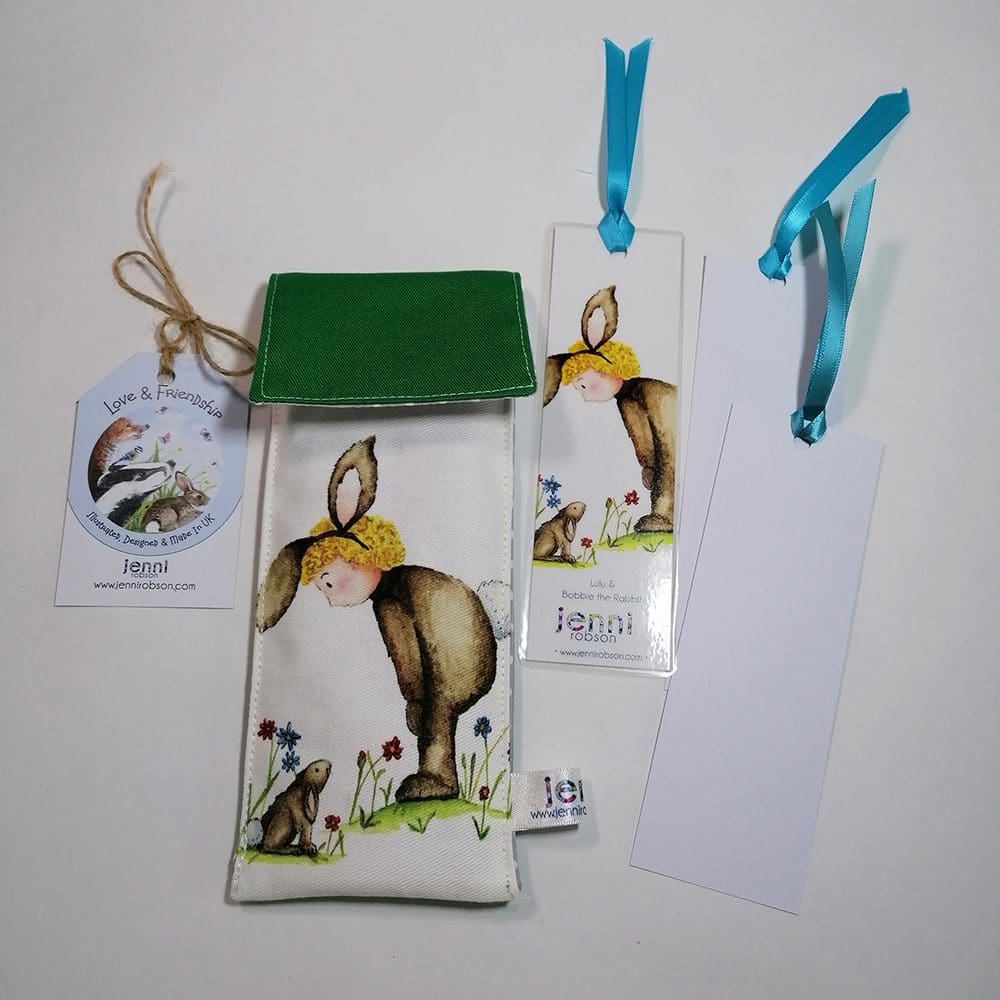 Handmade cotton pouch containing 8 colouring pencils, a laminated, printed bookmark and two blank bookmarks ready to be coloured with satin ribbon decoration. Set features Lulu and Bobbie rabbit