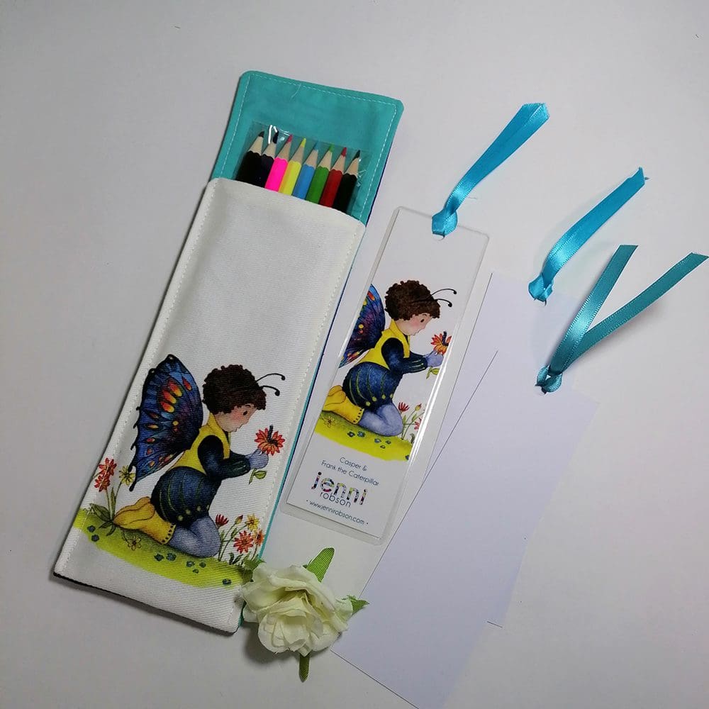Handmade cotton pouch containing 8 colouring pencils, a laminated, printed bookmark and two blank bookmarks ready to be coloured with satin ribbon decoration. Set features Casper and Frank the caterpillar