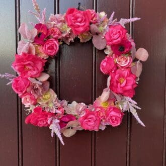 Bright pink front door wreath