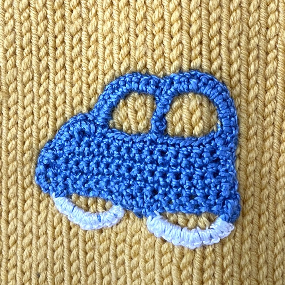 crochet blue car motif on yellow toddler cardigan
