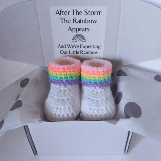 Rainbow Baby pregnancy reveal announcement gift, including a pair of rainbow baby booties which are handmade to order. These are wrapped and wording added to the box.