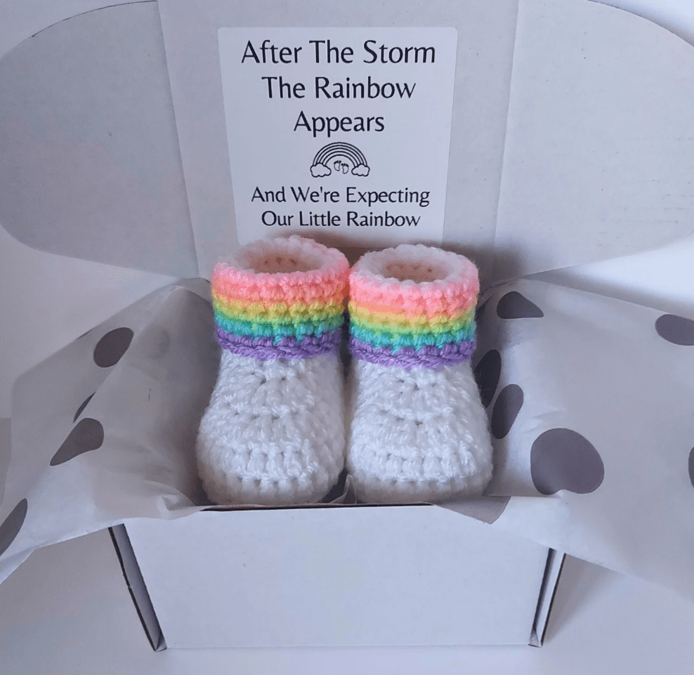 Rainbow Baby pregnancy reveal announcement gift, including a pair of rainbow baby booties which are handmade to order. These are wrapped and wording added to the box.