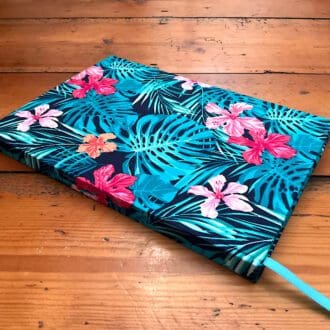 A5 handmade lined paper notebook covered in a Tropical themed blue and pink fabric