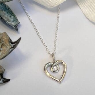 Handmade silver heart outline necklace with cubic zirconia stone